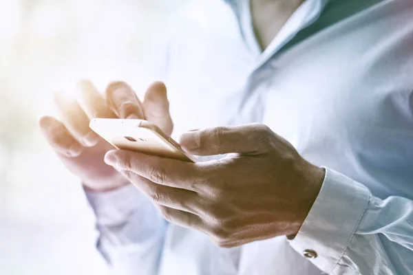 Businessman hand holding smart phone — Stock Photo, Image
