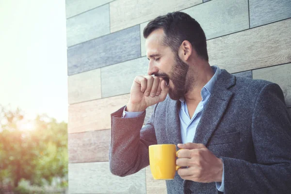Businessman Yawning Holding Morning Coffee Wall Background — Stock Photo, Image