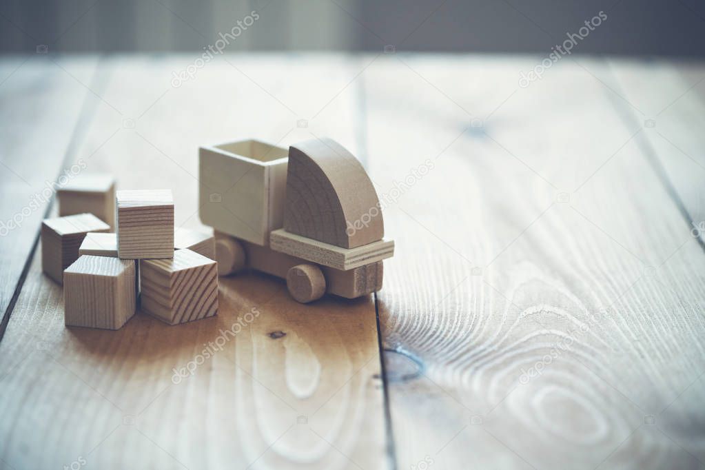 Wooden model of truck loading freight. Shipping and delivery concept