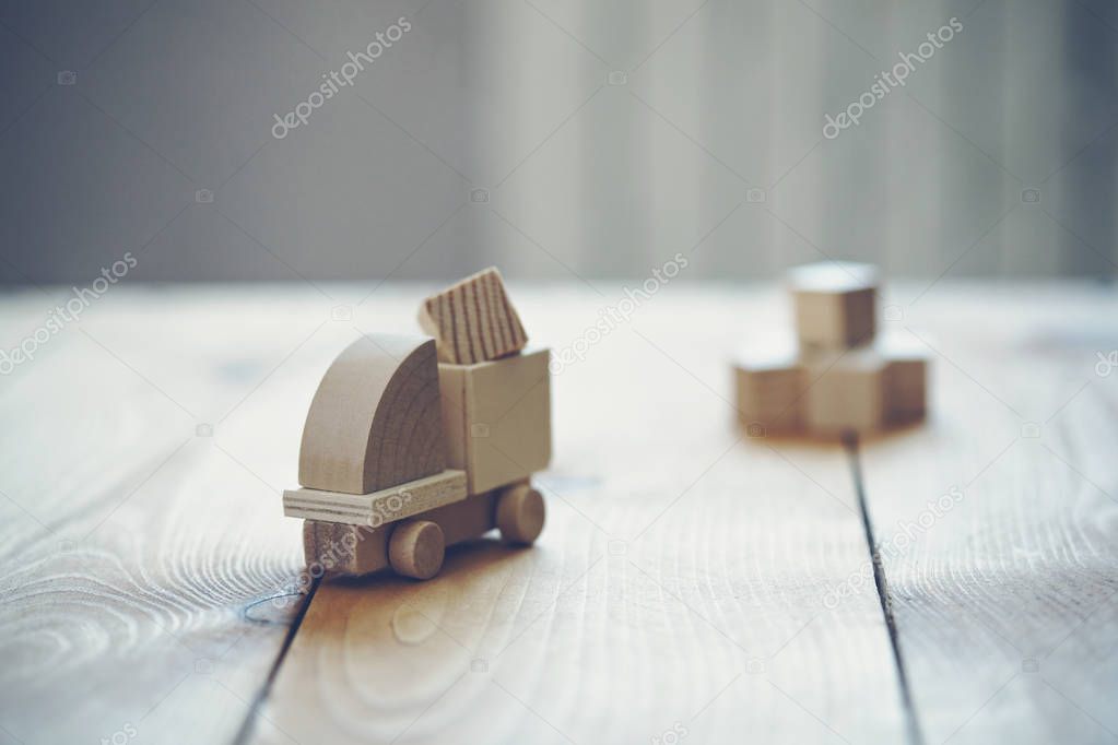 Wooden model of truck loading freight. Shipping and delivery concept