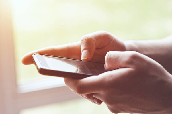 close-up view of hands using smart phone touching screen with fingers