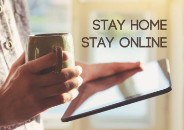 Dijital tableti kahve ve mesajla tutan eller evde kalsın. Coronavirus covid-19 salgını sırasında ev izolasyonu ve karantina.