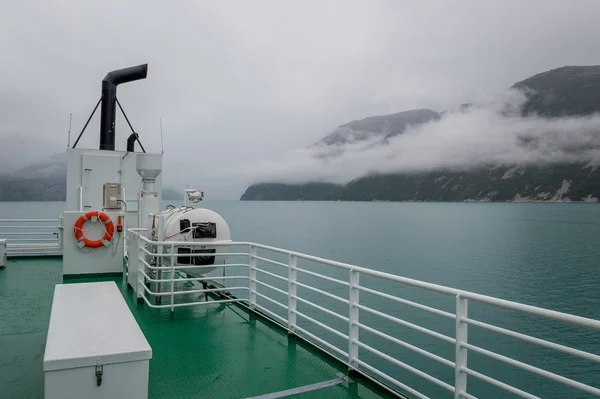 Vista de la cubierta del ferry a las montañas del fiordo en nubes y niebla . — Foto de Stock