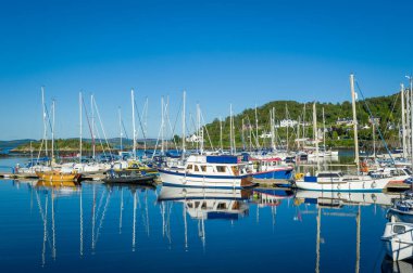 Tarbert marina with perfect blue sea and sky.