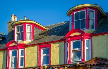 Colorful walls and windows of Tarbert historic buildings.