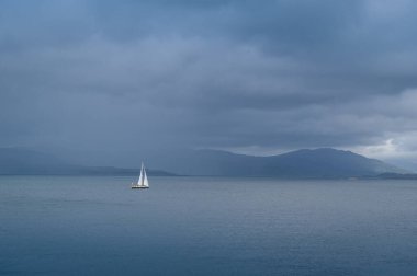 Sailing yacht at Hebrides islands clipart