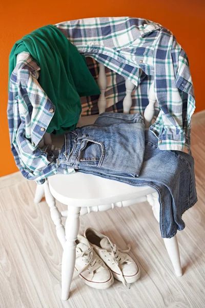 Teenage clothes on a chair — Stock Photo, Image