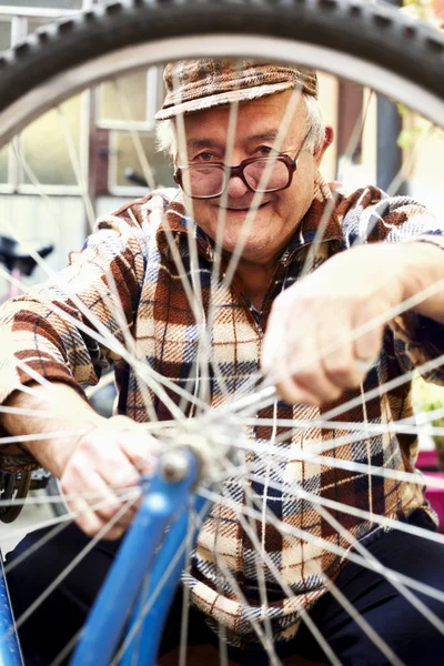 elderly man serviced bikes