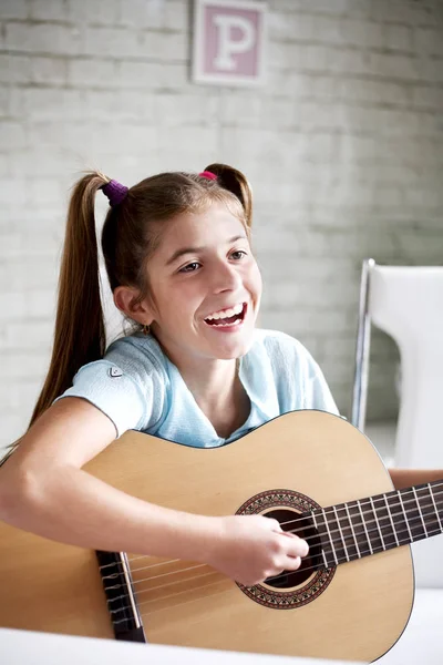 Girl playing guitar at school