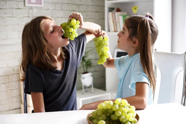 Teenagers eating grapes