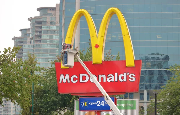 Munkás és a Mcdonald's logó — Stock Fotó