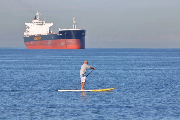 Paddle Boarder and Bulk Freighter — Stock Photo, Image