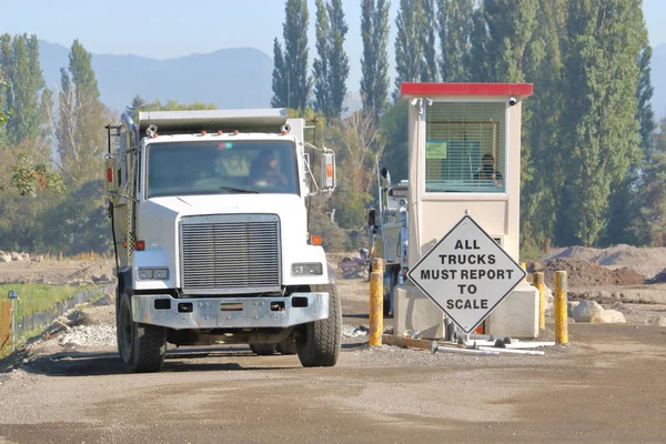 An industrial weigh station where dump trucks and their load are measured.