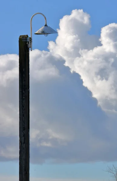 Rolling Cumulus Clouds Backdrop Old Outdoor Lamp Mounted Wooden Post — Stock Photo, Image