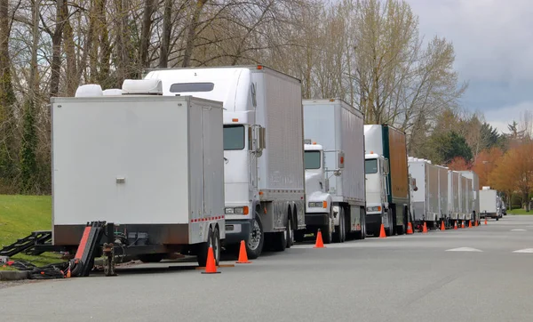 A commercial film mobile unit is parked in a neighborhood where the production will be shot.