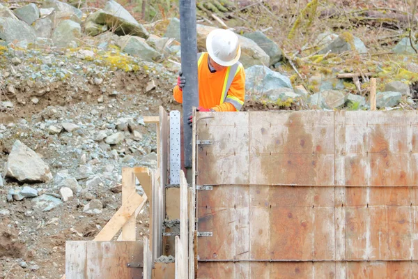 Medium View Construction Site Worker Handling Hose Feeds Liquid Cement — Stock Photo, Image