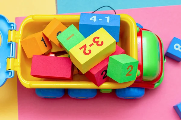 pack of colorful child kids education toys constructor train pattern on the bright color background close up. Childhood education play infancy children baby concept