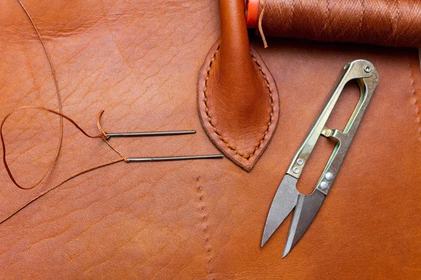 Sewing brown leather bag. Leather craft process.
