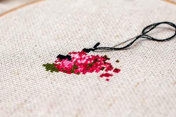 Cross stitching embroidery process. Needle embroidery frame threads. Hobby DIY lifestyle.