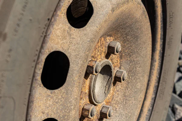 Old rusty steel auto wheel disc, car service.