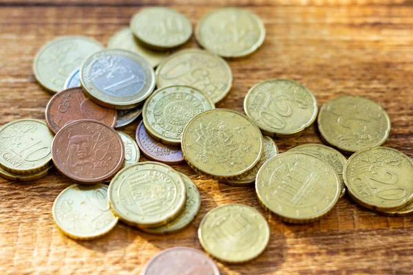 coins old rusty brass euro pile pack heap stack on a wooden background finance economy investment savings concept mock up selective focus close up