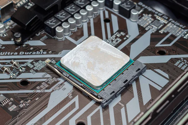 Powerful CPU with applied thermal grease on a personal computer. The process computer maintenance upgrading installing assembling PC in a service.