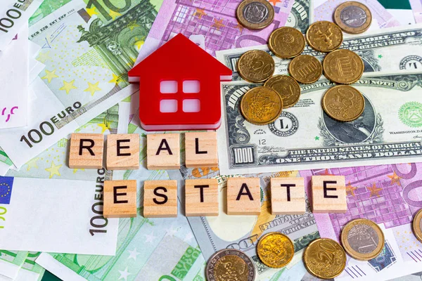 word text real estate or buy on the money banknotes background