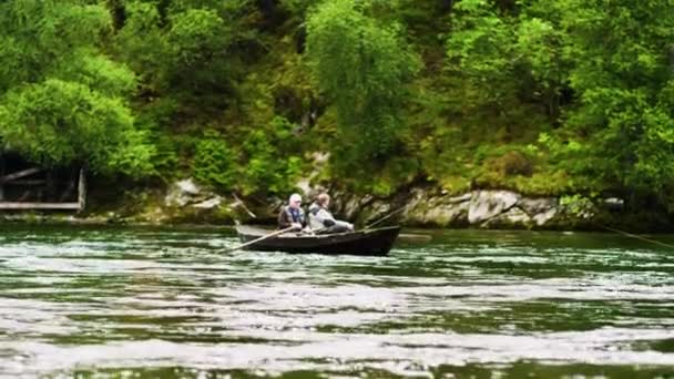 Senior men fishing from boat — Stock Video