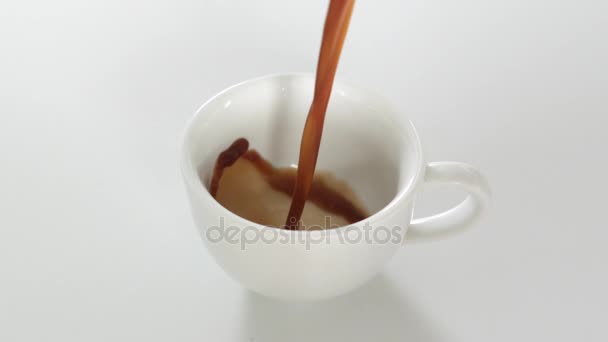 Café noir étant versé dans la tasse 