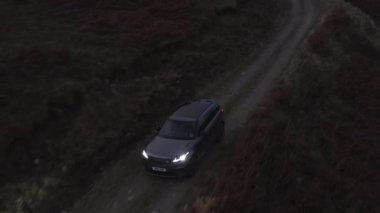 Kirli yolda giden bir SUV 'un İzleme Çekimi