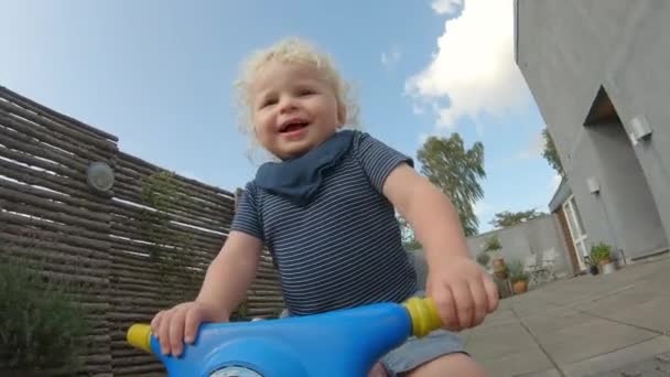 Adorable Closeup Shot of Danish Toddler Riding His Bike All Around the Backyard — ストック動画