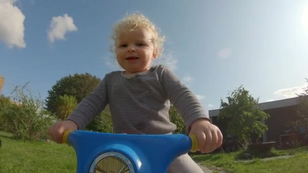 Closeup Shot of an Adventurous Toddler Riding His Bike Outside the House — Stok video