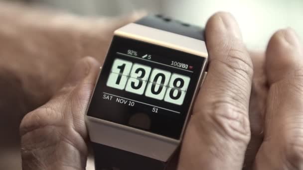 Man Checking His Heart Rate Using a Smart Wristwatch on a Blurred out Background — Stock Video