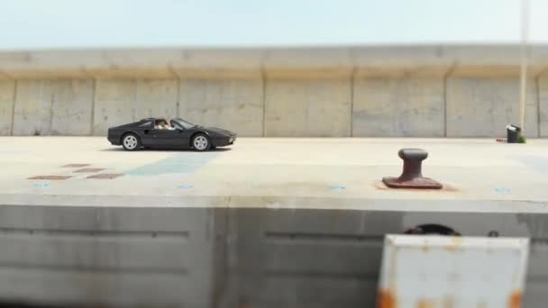 Shot of a Ferrari GTS Being Driven by a Man by the Docks — Wideo stockowe