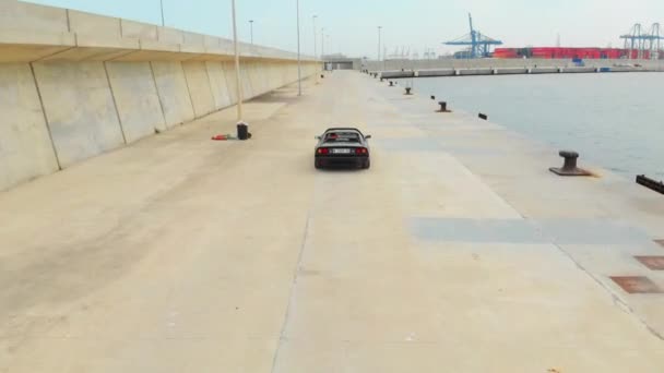 Black Ferrari Cruising by the Docks — Stok video