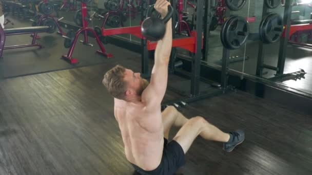 Slow motion shot of an athlete doing a Complete Kettlebell Situp — Stock video