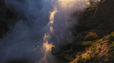 Sunlit Clouds And Mountain Tops At Sunrise