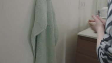 Girl Drying Hands On Bathroom Towel After Washing
