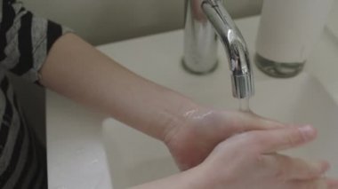 Girl Thoroughly Rinsing Hands After Washing