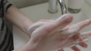 Girl Covering Hands With Soap Suds From Sanitizer