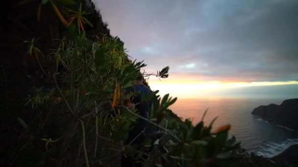 Man Walking Narrow Path Passed Cacti On Mountainside — Stock video