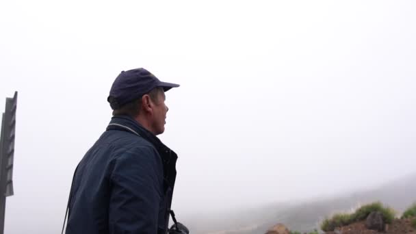 Hombre caminando bajo cielo nublado — Vídeo de stock