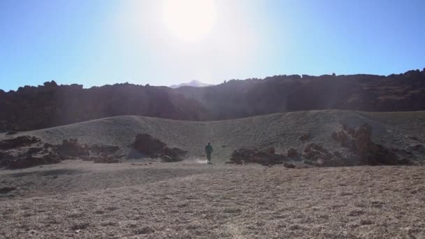 Man Walking In Dry Desert Like Location — Stock Video