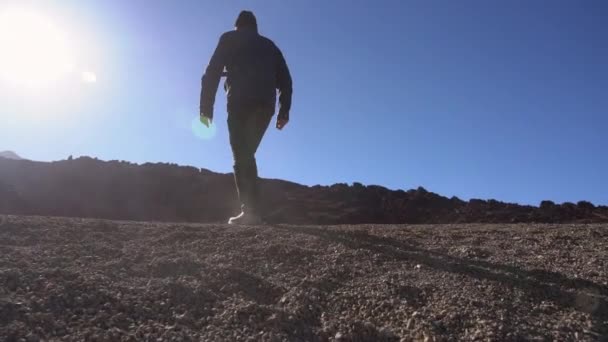 Man Walking Through Moon Like Location Of Stones And Gravel — Stock video