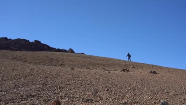 Man Walking Through Desert Moon Like Location — Stock video