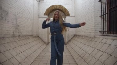 Blond Girl In Jumpsuit Dancing In Tunnel