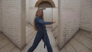 Blond Girl In Jumpsuit Dancing In Tunnel