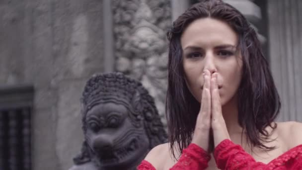 Brünette tanzen im roten Kleid vor dem Tempel — Stockvideo