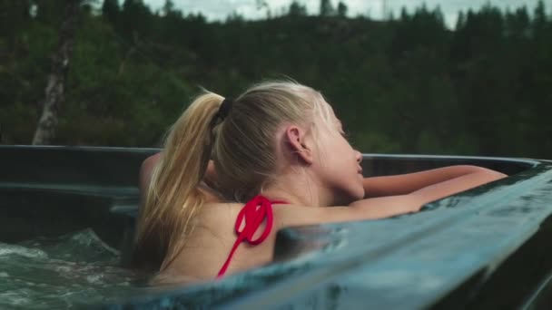 Jeune femme blonde relaxant dans un bain à remous — Video