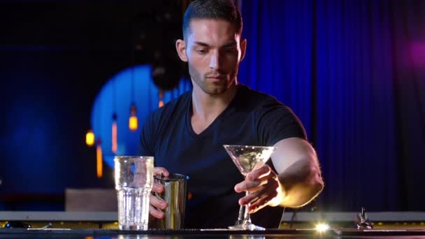 Handsome Male Bartender Throws Ice from the Glass and Pours a Drink — Stock Video